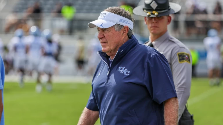 Carton Grills Bill Belichick for Sideline Chat with Jordon Hudson