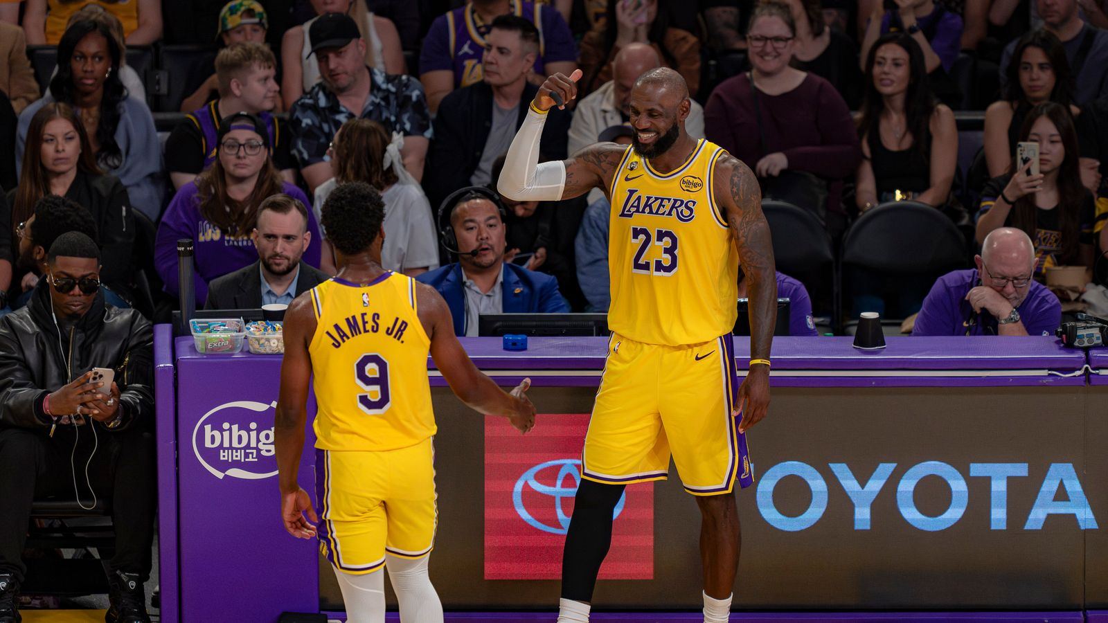 LeBron James Shares a Smile with Son Bronny James Jr. During a Sub