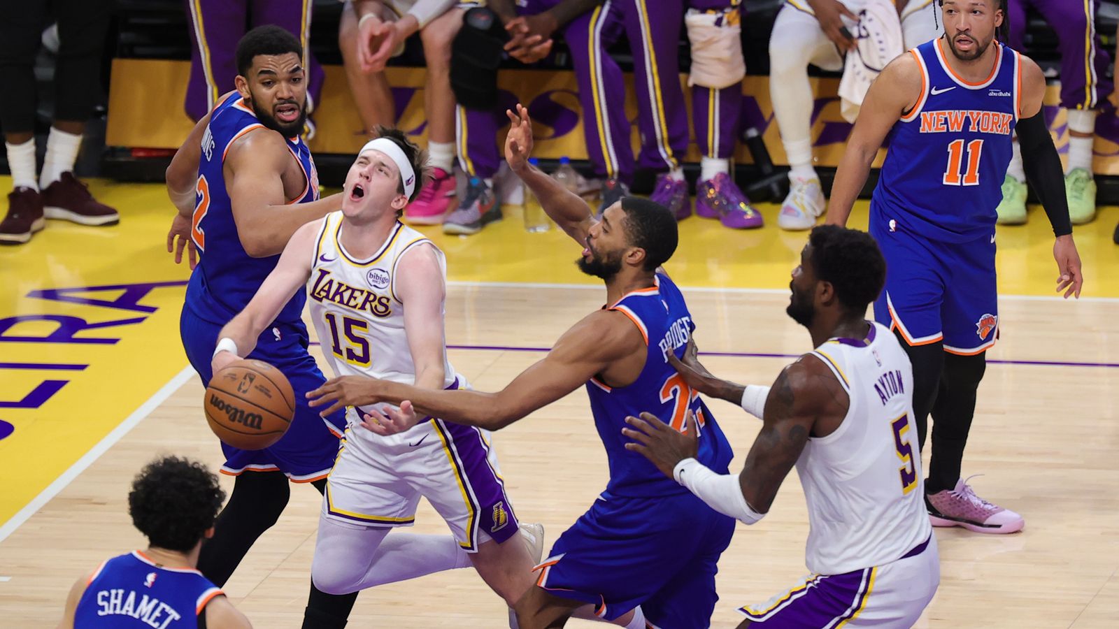 Los Angeles Lakers guard Austin Reaves (15) is fouled driving the lane during an NBA game against the New York Knicks on March 8, 2026 in Los Angeles, CA.