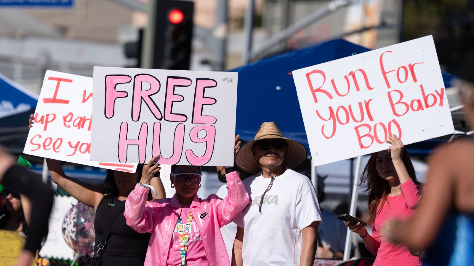 Spectators hold signs along the course during the Los Angeles Marathon on Sunday, March 8, 2026, in Los Angeles.