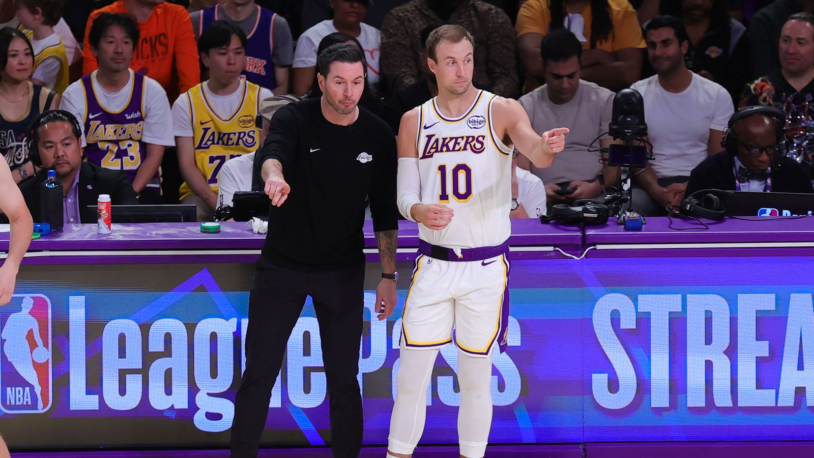 Los Angeles Lakers head coach JJ Redick and guard Luke Kennard (10) discuss strategy during an NBA game against the New York Knicks on March 8, 2026 in Los Angeles, CA.