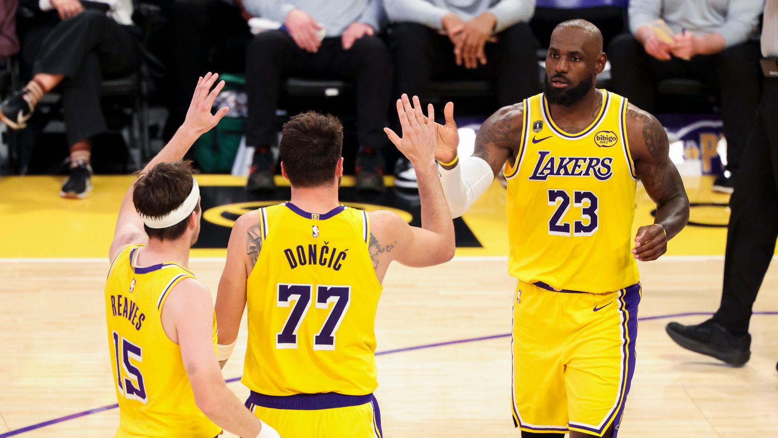 LeBron James #23 high fives Luka Dončić #77 and Austin Reaves #15 of the Los Angeles Lakers during an NBA basketball game against the Chicago Bulls, Thursday March 12, 2026 in Los Angeles, Calif.