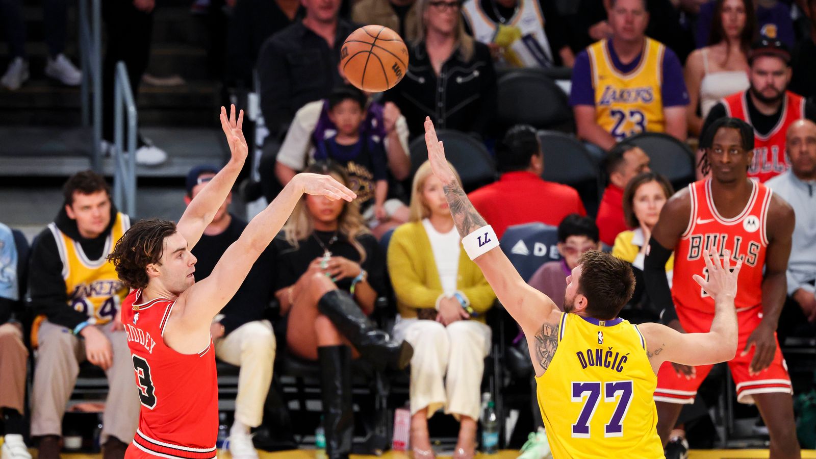 Josh Giddey #3 of the Chicago Bulls shoots the ball over Luka Dončić #77 of the Los Angeles Lakers during an NBA basketball game, Thursday March 12, 2026 in Los Angeles, Calif.