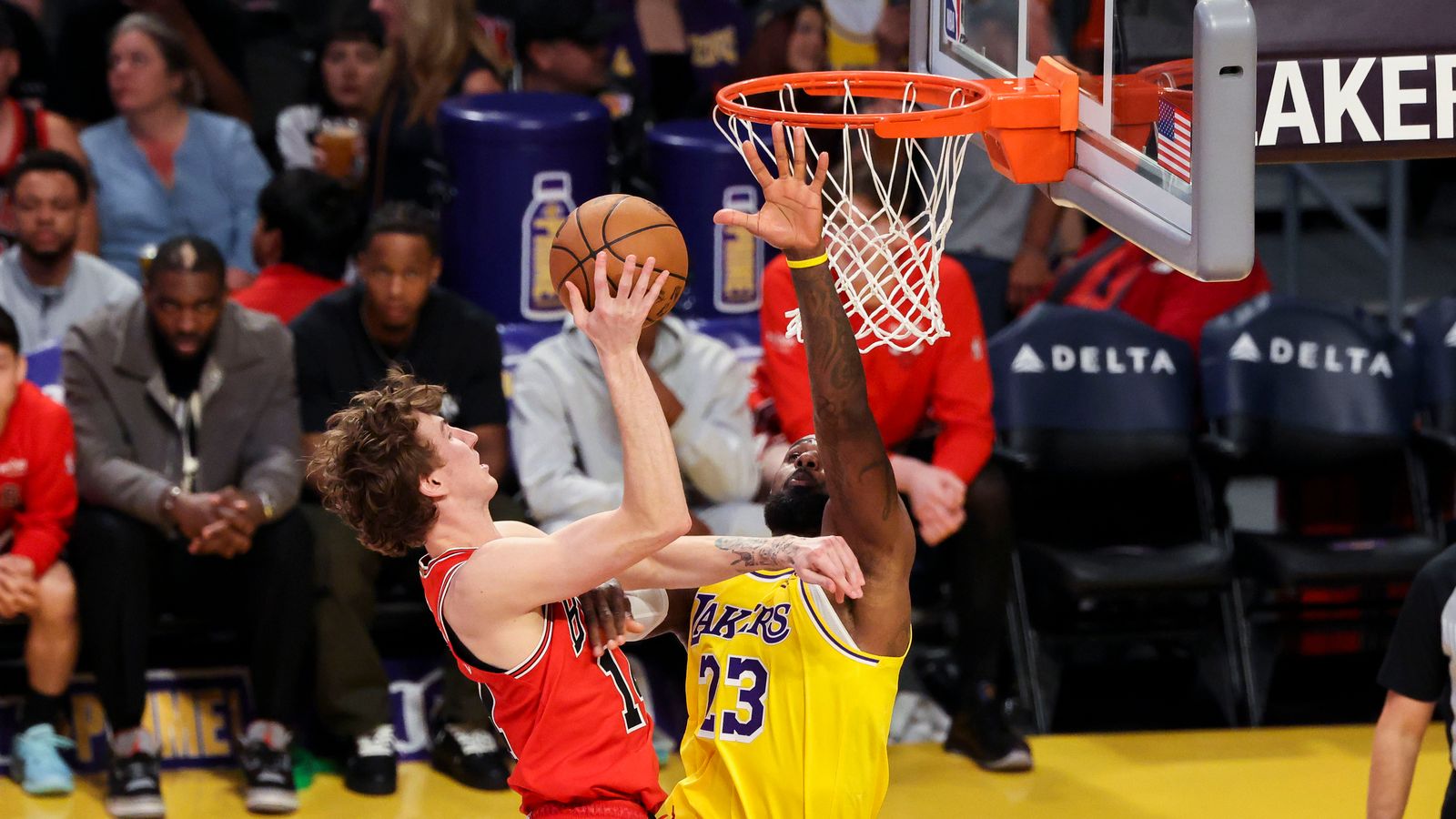 Matas Buzelis #14 of the Chicago Bulls lays the ball up over LeBron James #23 of the Los Angeles Lakers during an NBA basketball game, Thursday March 12, 2026 in Los Angeles, Calif.