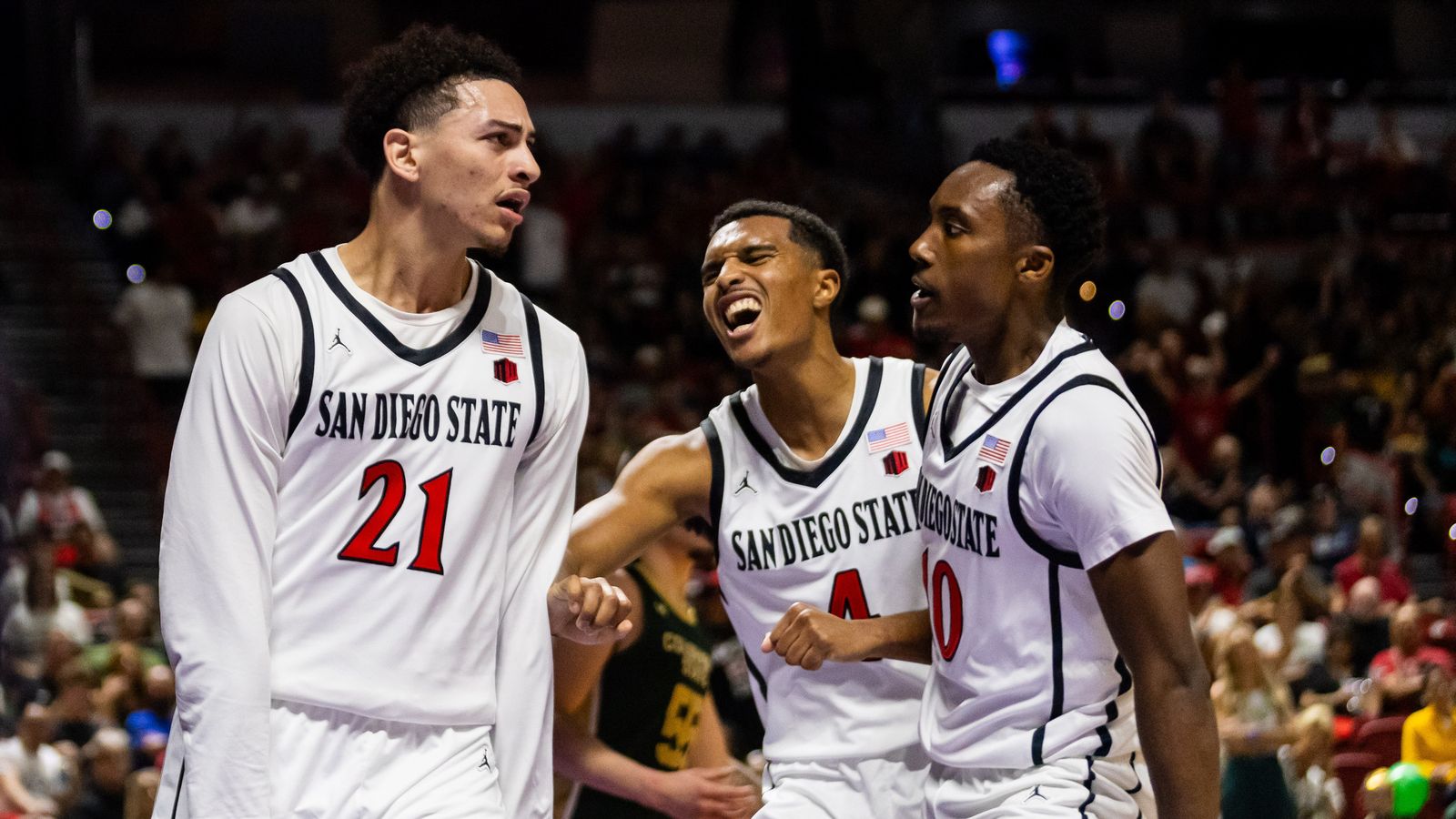 San Diego Aztecs guard Miles Byrd (21) celebrates with guard Sean Newman Jr. (4) and guard BJ Davis (10) after Byrd makes an and-one basket during a Mountain West Championship tournament quarterfinal game between the San Diego Aztecs and the Colorado State Rams, Thursday March 12, 2026 in Las Vegas, Nev.