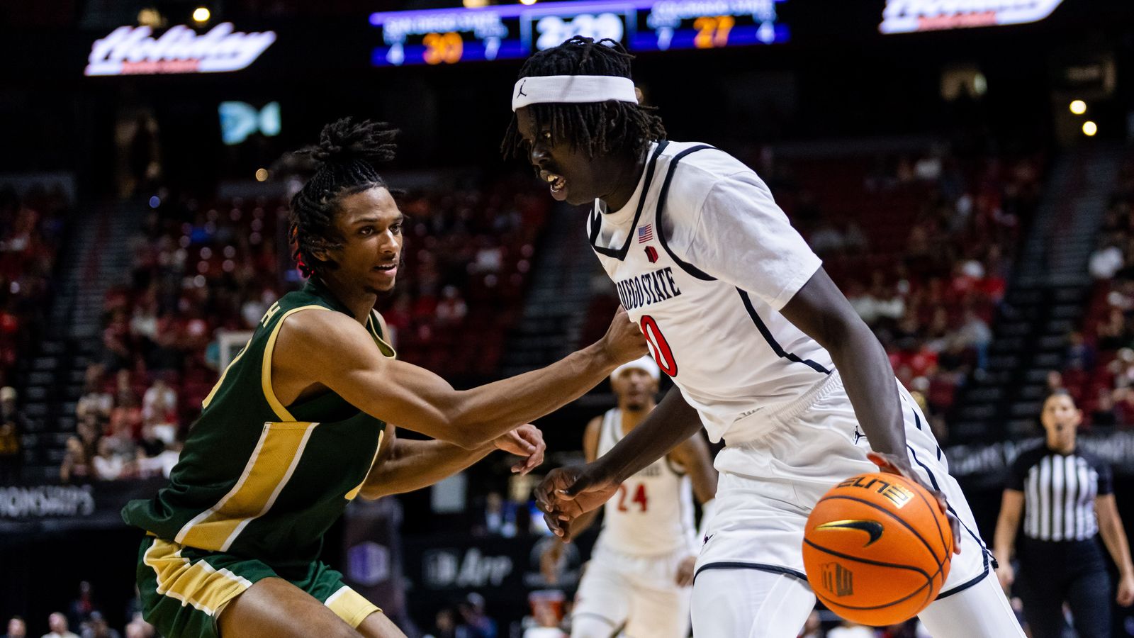 San Diego Aztecs forward Magoon Gwath (0) dribbles the ball along the baseline during a Mountain West Championship tournament quarterfinal game between the San Diego Aztecs and the Colorado State Rams, Thursday March 12, 2026 in Las Vegas, Nev.
