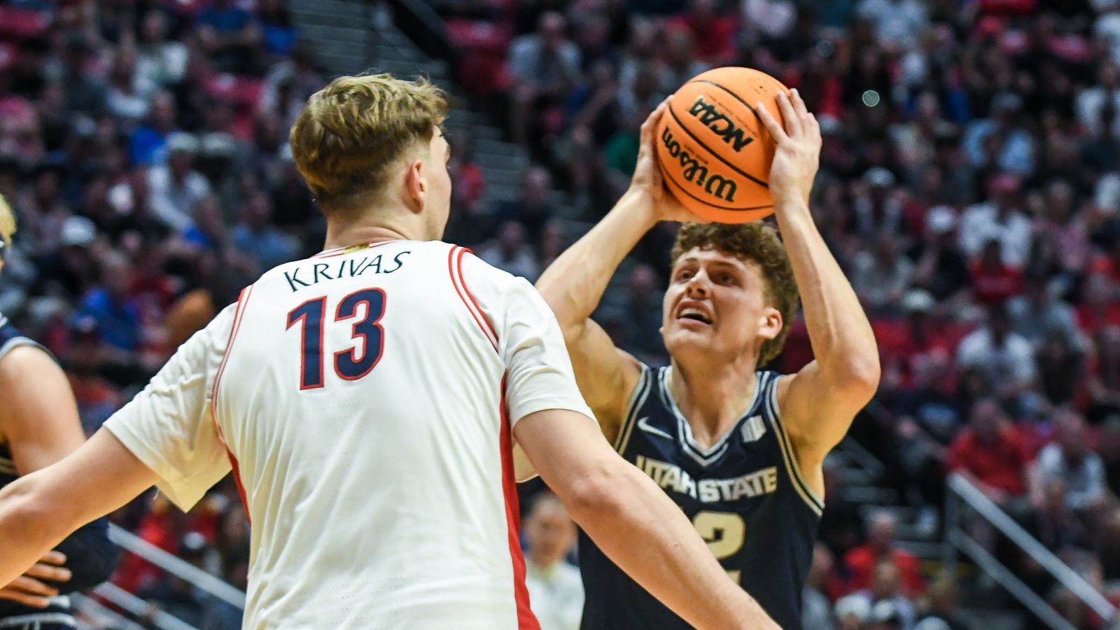 Utah State guard Mason Falslev (12) looks to shoot during an NCAA East Region second round game against  Arizona Sunday March 22, 2026 in  San Diego, California.