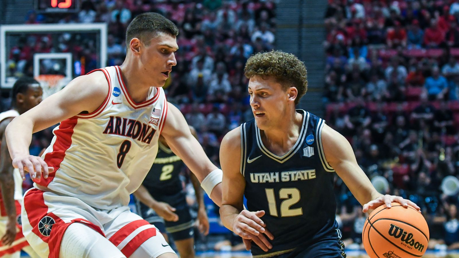 Utah State guard Mason Falslev (12) dribbles the ball during an NCAA East Region second round game against  Arizona Sunday March 22, 2026 in  San Diego, California.