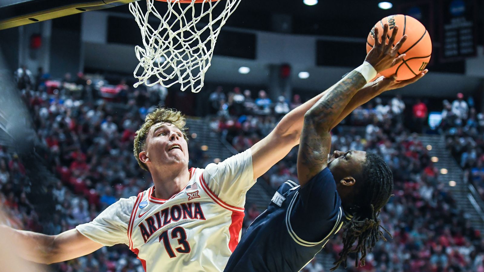 Arizona center Motiejus Krivas (13) contest the shot of Utah State guard Kolby King (7) during an NCAA East Region second round game against  Utah State Sunday March 22, 2026 in  San Diego, California.