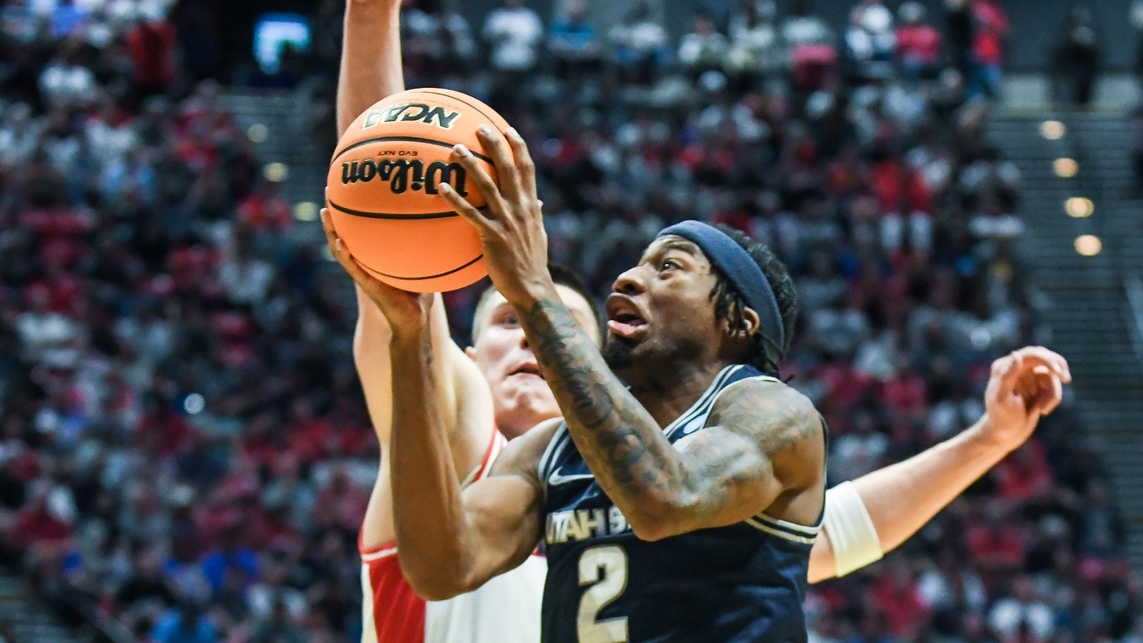 Utah State guard MJ Collins Jr. (2) makes a driving layup during an NCAA East Region second round game against  Arizona Sunday March 22, 2026 in  San Diego, California.
