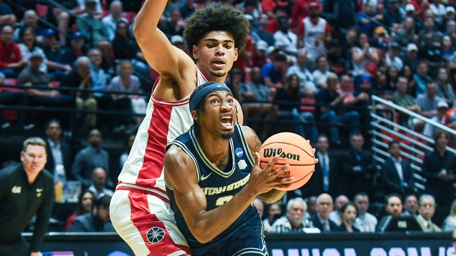 Utah State guard MJ Collins Jr. (2) drives to the basket during an NCAA East Region second round game against  ArizonaSunday March 22, 2026 in  San Diego, California.