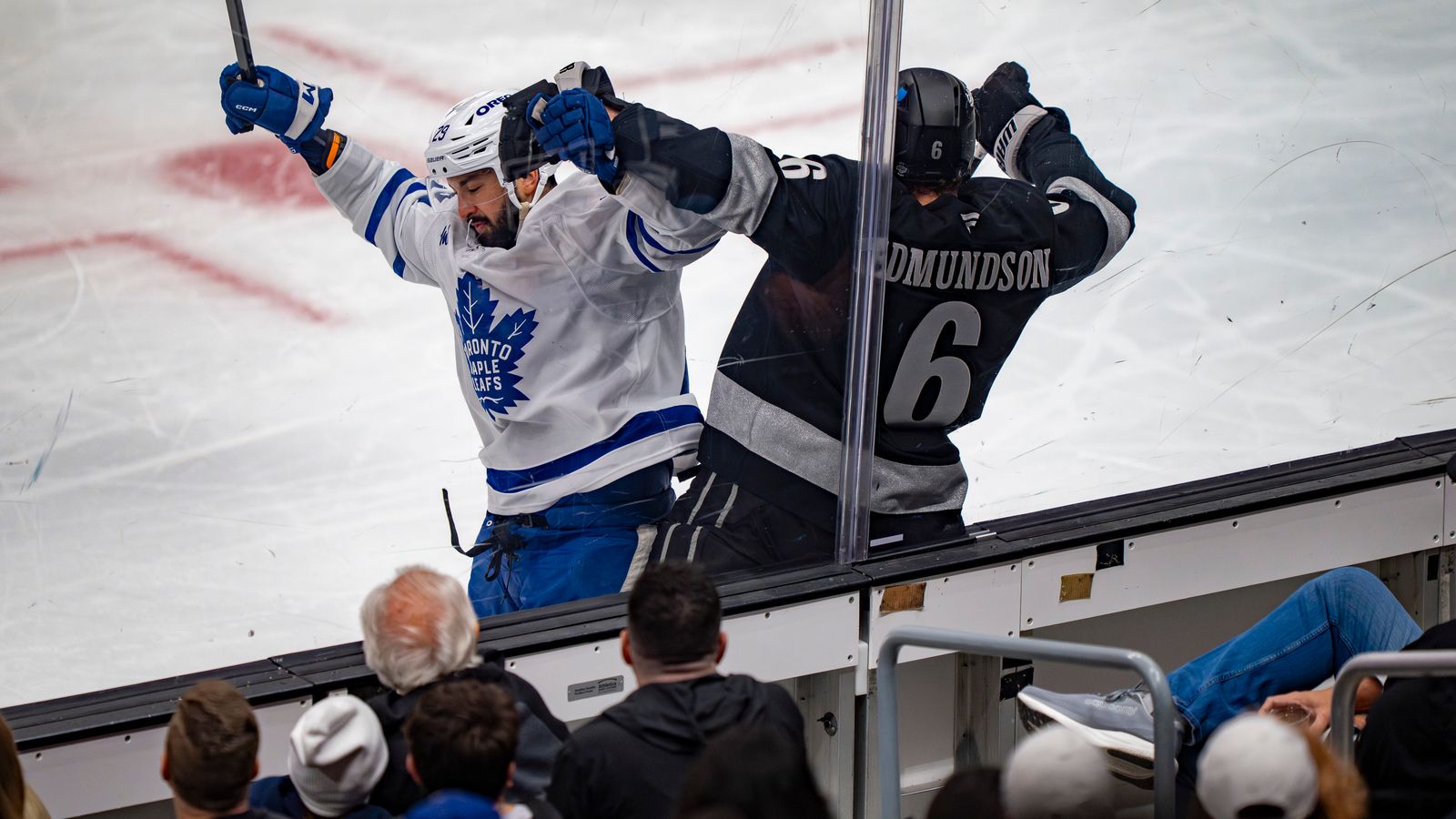 Kings Joel Edmundson (6) being crushed against the glass
