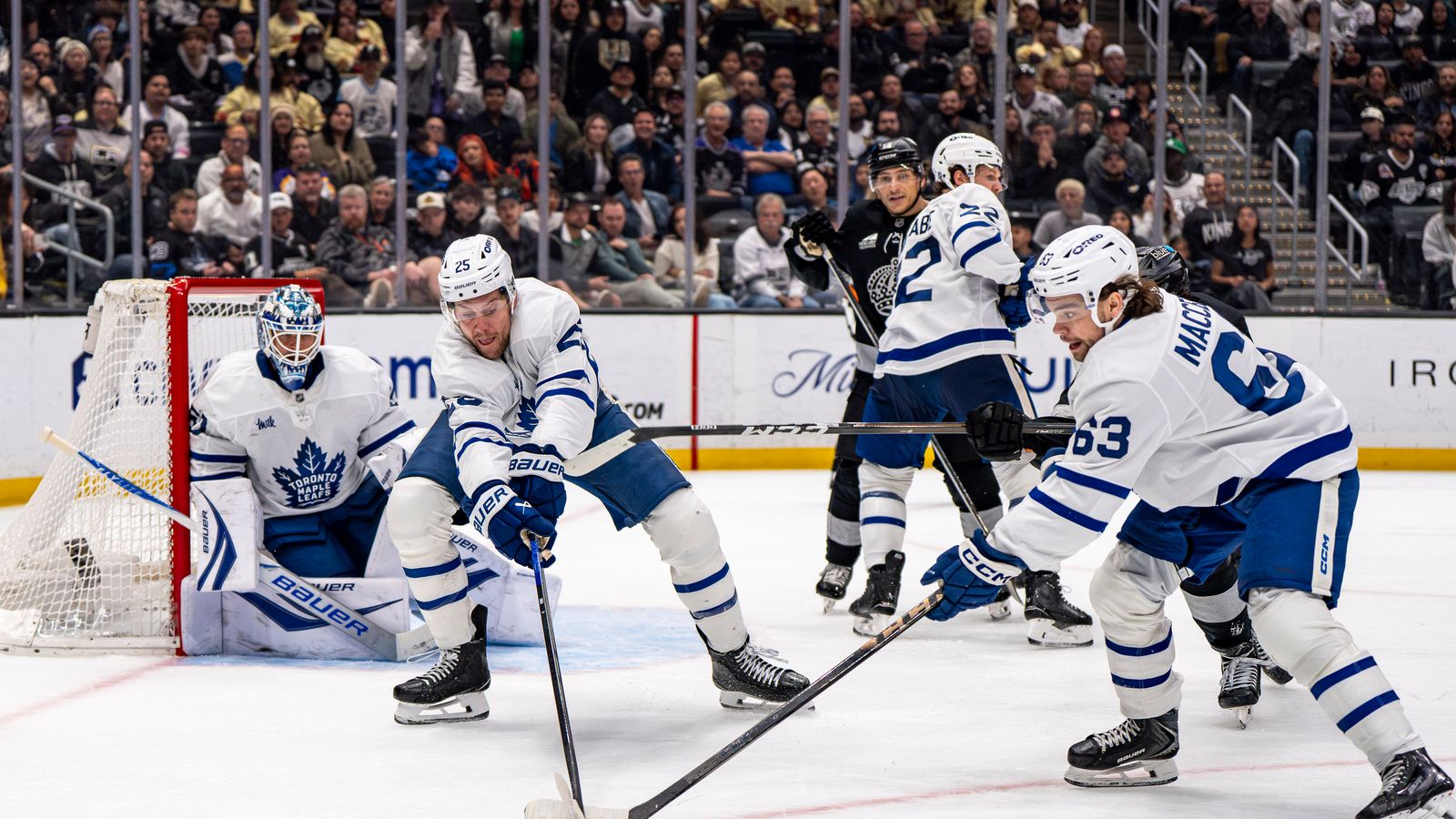 Maple Leafs Brandon Carlo (25) retrieving the puck