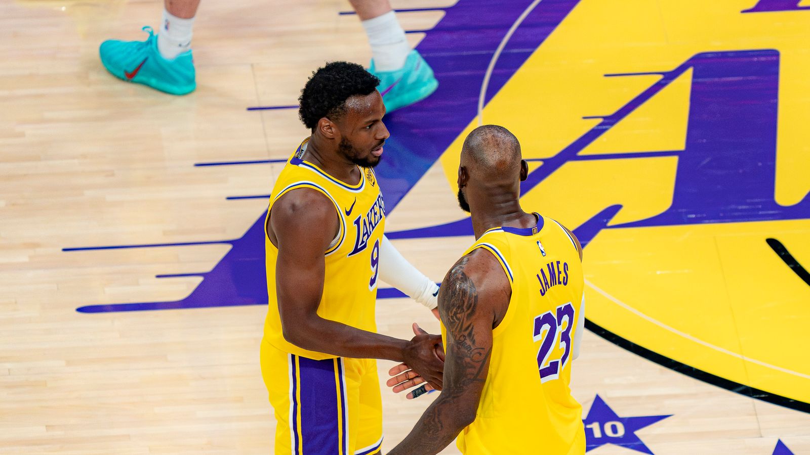 Lakers guard Bronny James Jr. (9) talking with his father LeBron James