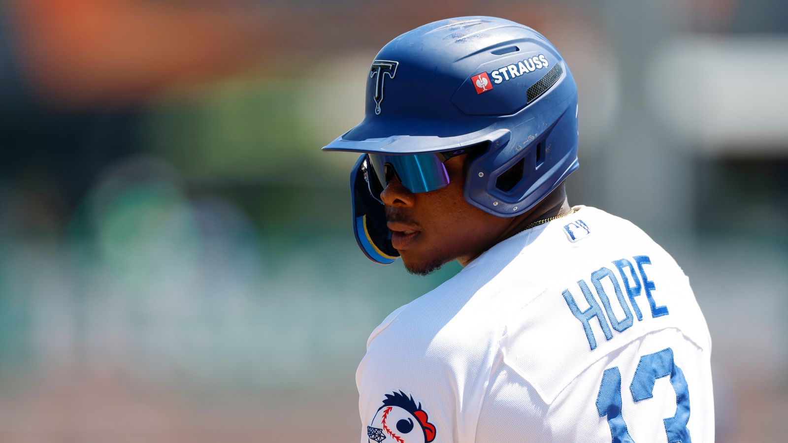 Zyhir Hope Monitors the Play from First Base