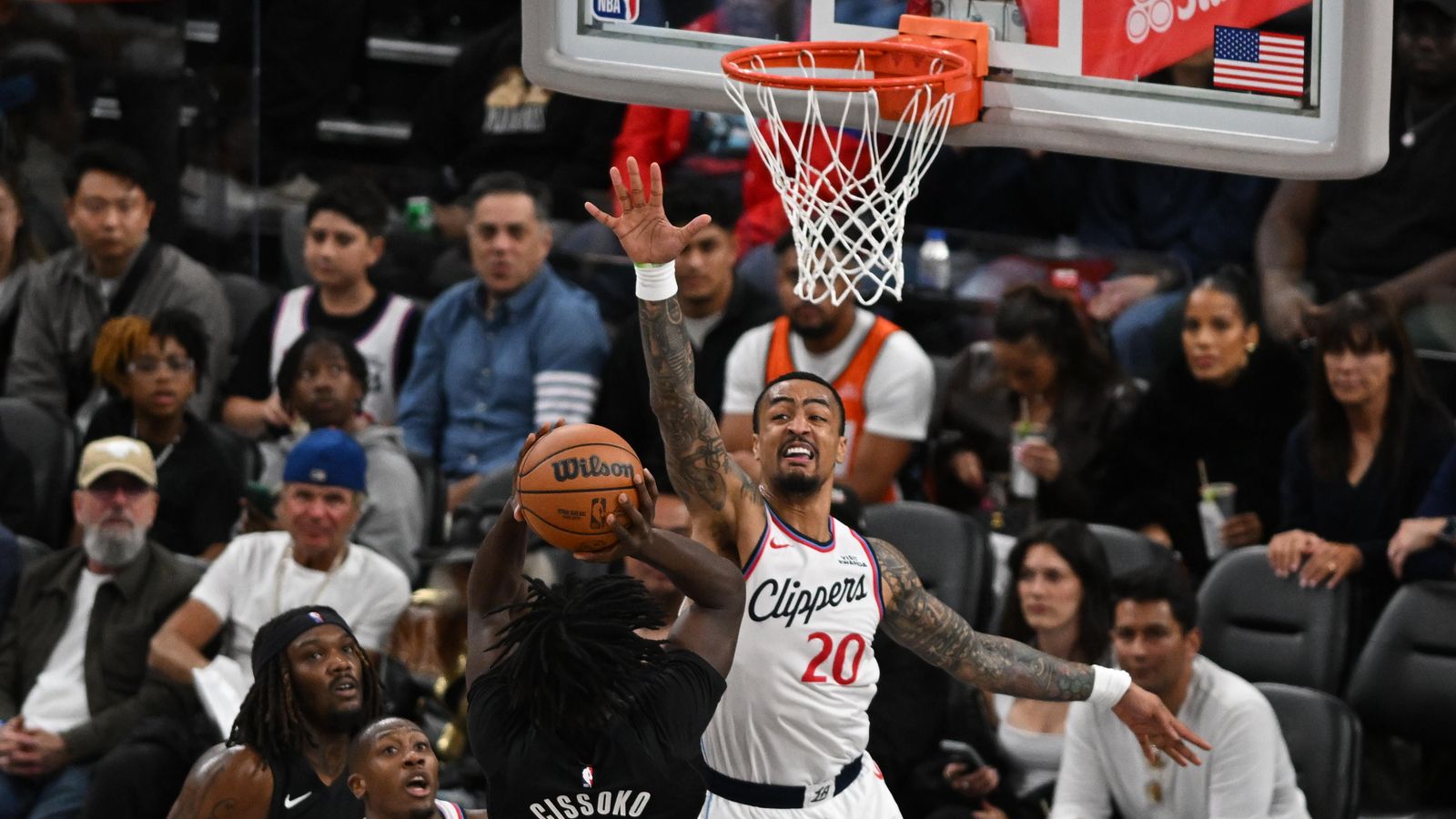 Rim Protection: John Collins reaches high to swat away a Blazer attempt