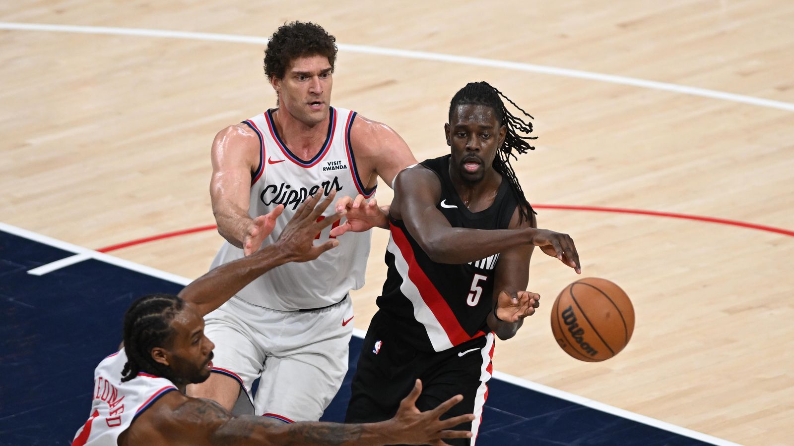 Veteran Vision: Jrue Holiday threads a pass through the Clippers' defense