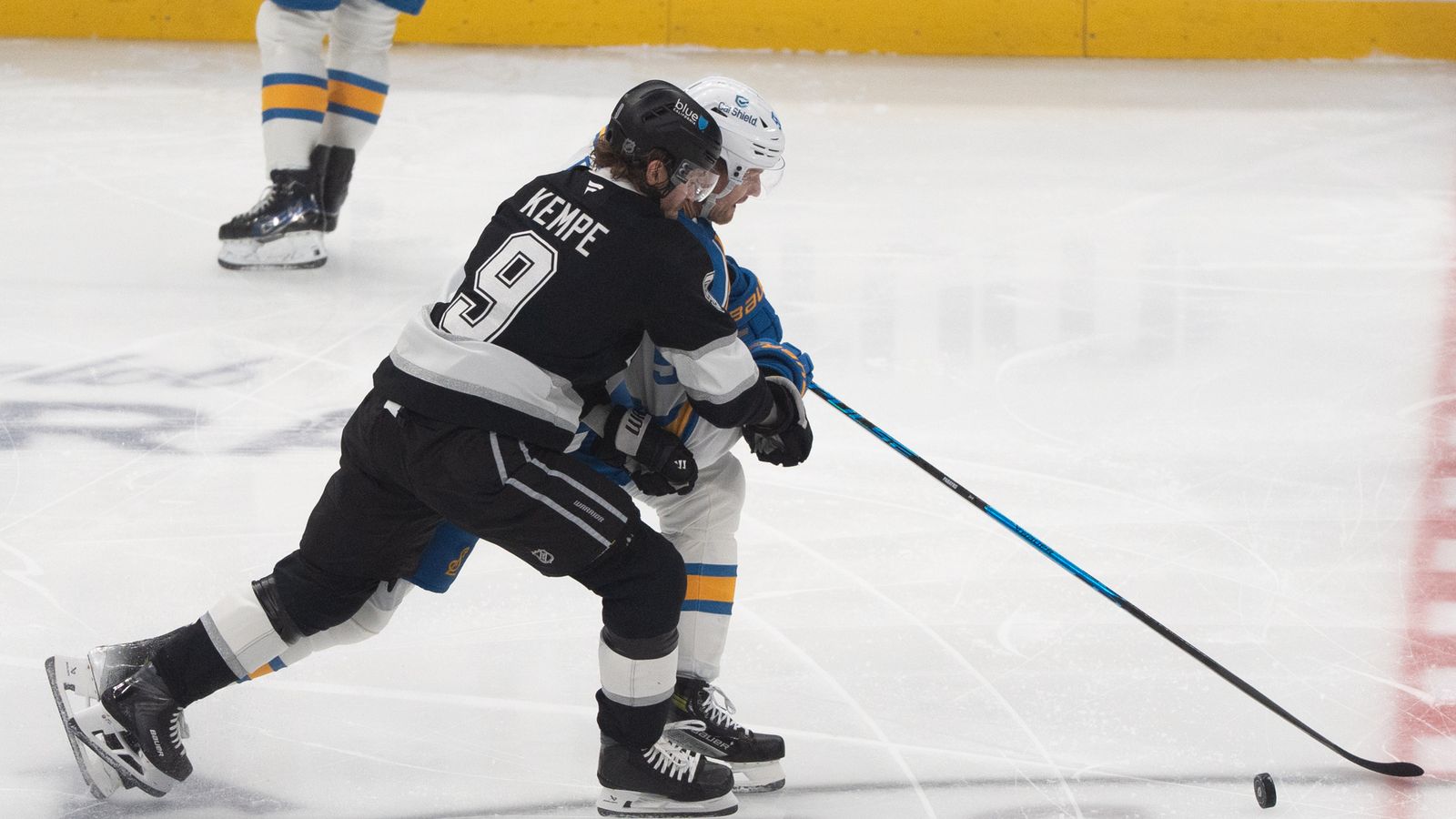 Battling for Position: Adrian Kempe fights through heavy traffic for puck control