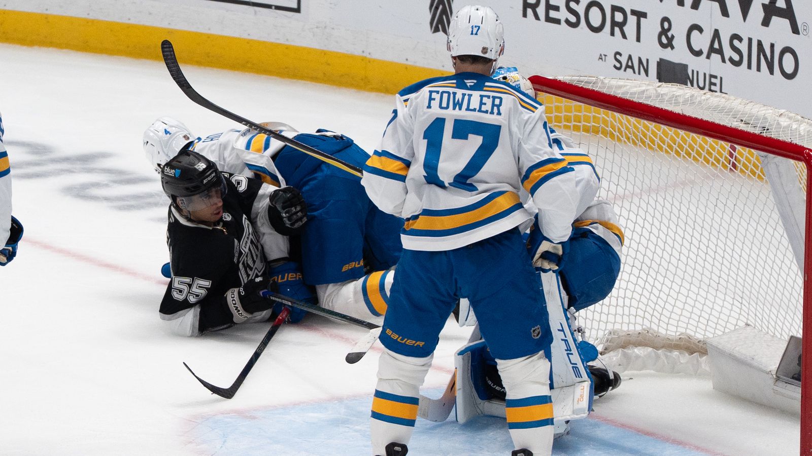 Taking the Hit: Quinton Byfield hits the ice after a physical play