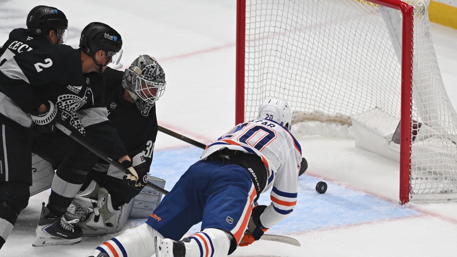 Oilers center Curtis Lazar (20) attempts to push the puck to the net