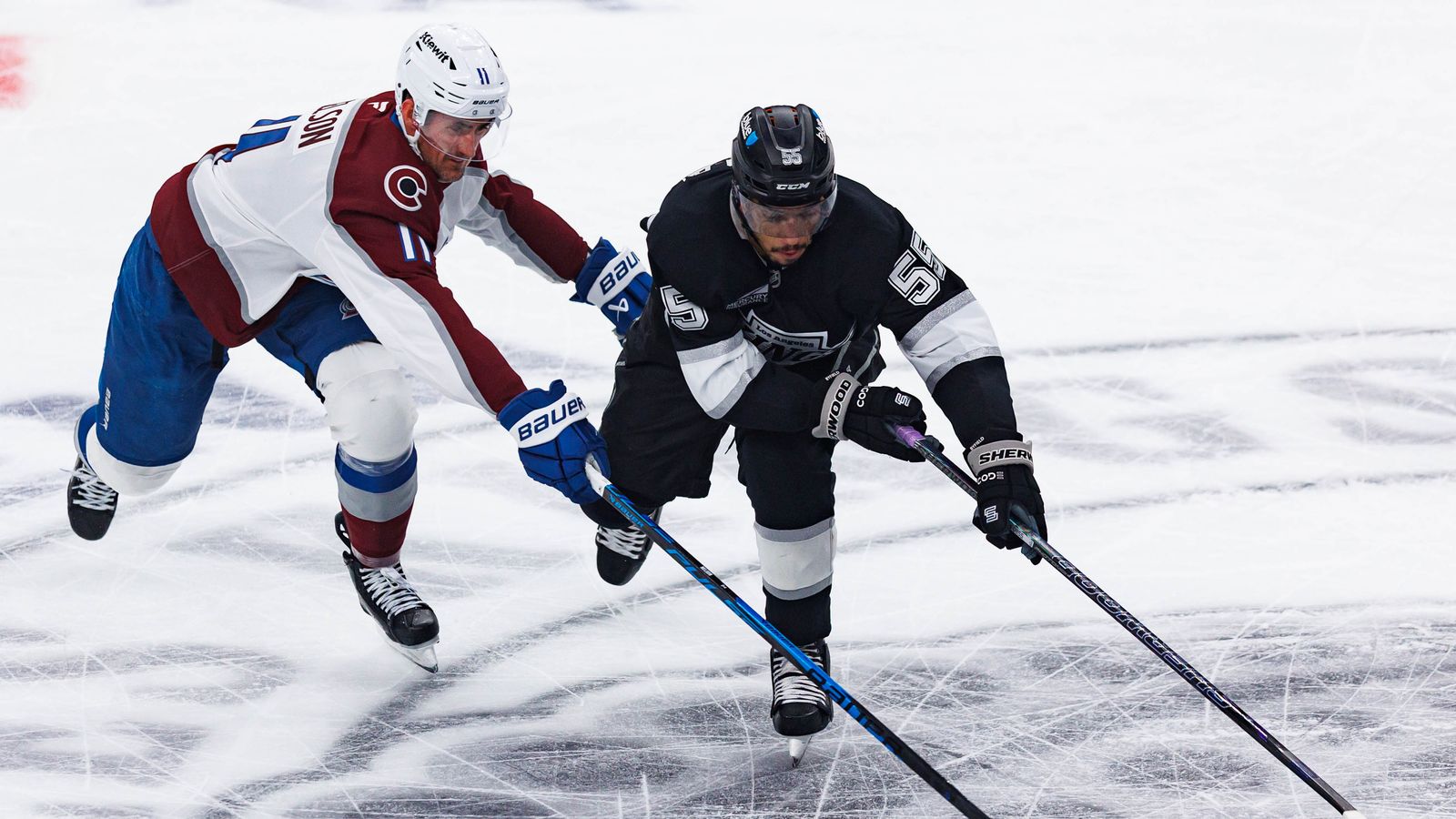 Quinton Byfield Protects the Puck Along the Boards