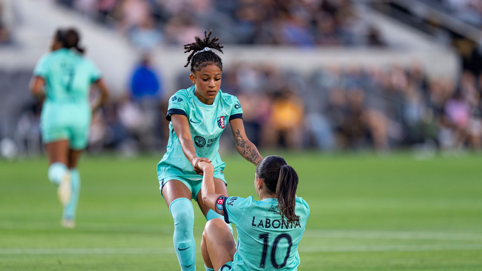 Lo'Eau LaBonita recovers after a foul in NWSL game