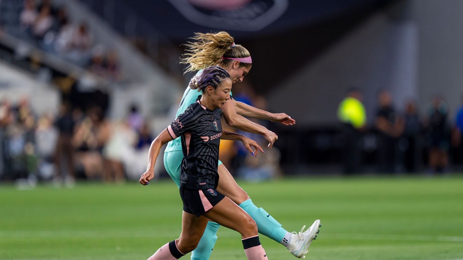 Jun Endo covers a defender in intense NWSL action