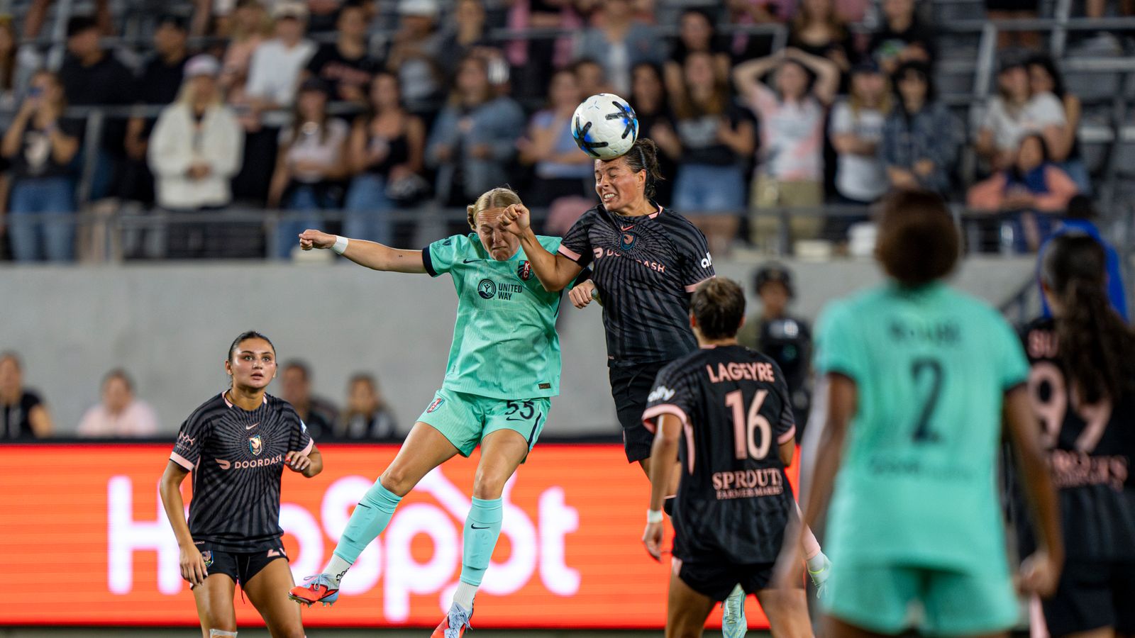 Emily Sams competes for a header in NWSL game
