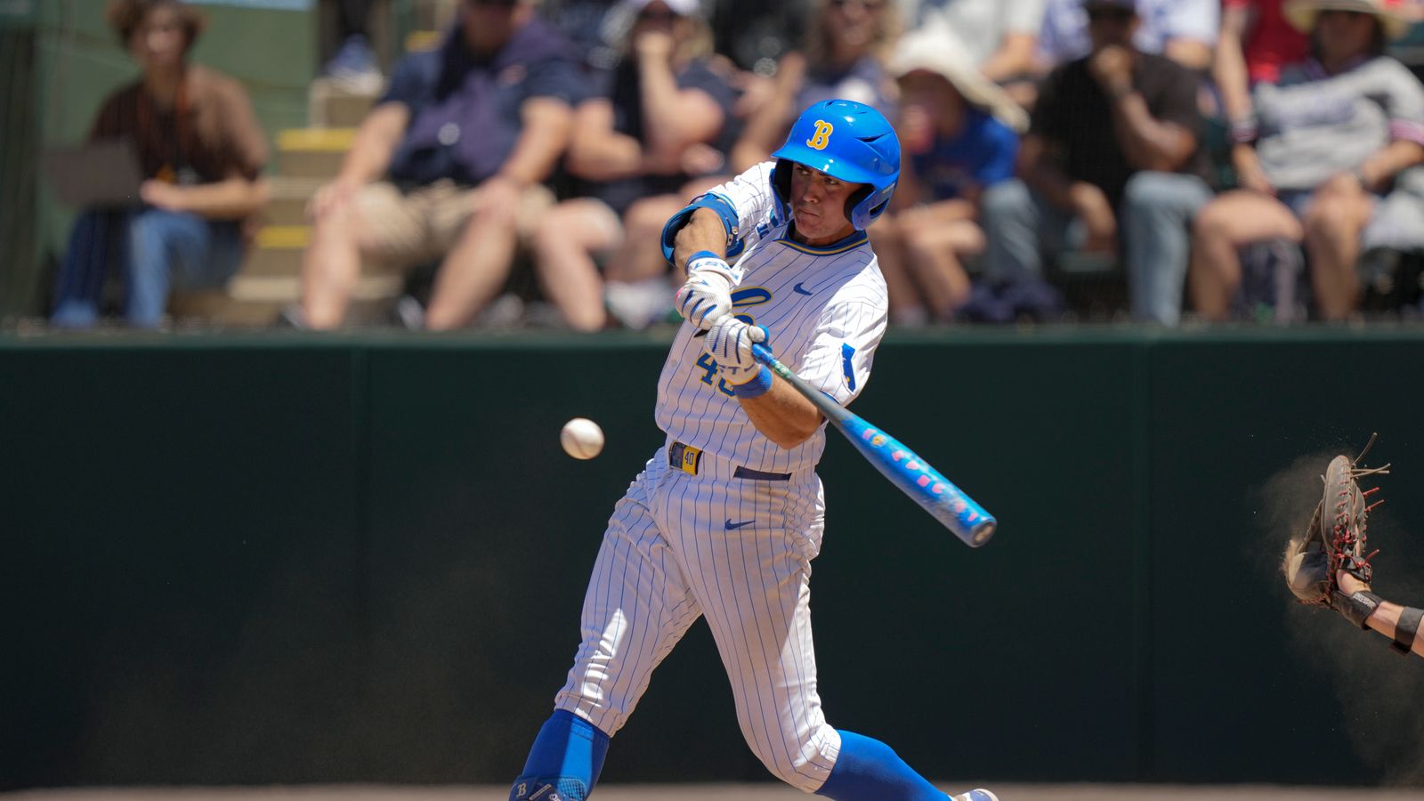 Cashel Dugger hits a ground ball in NCAA game