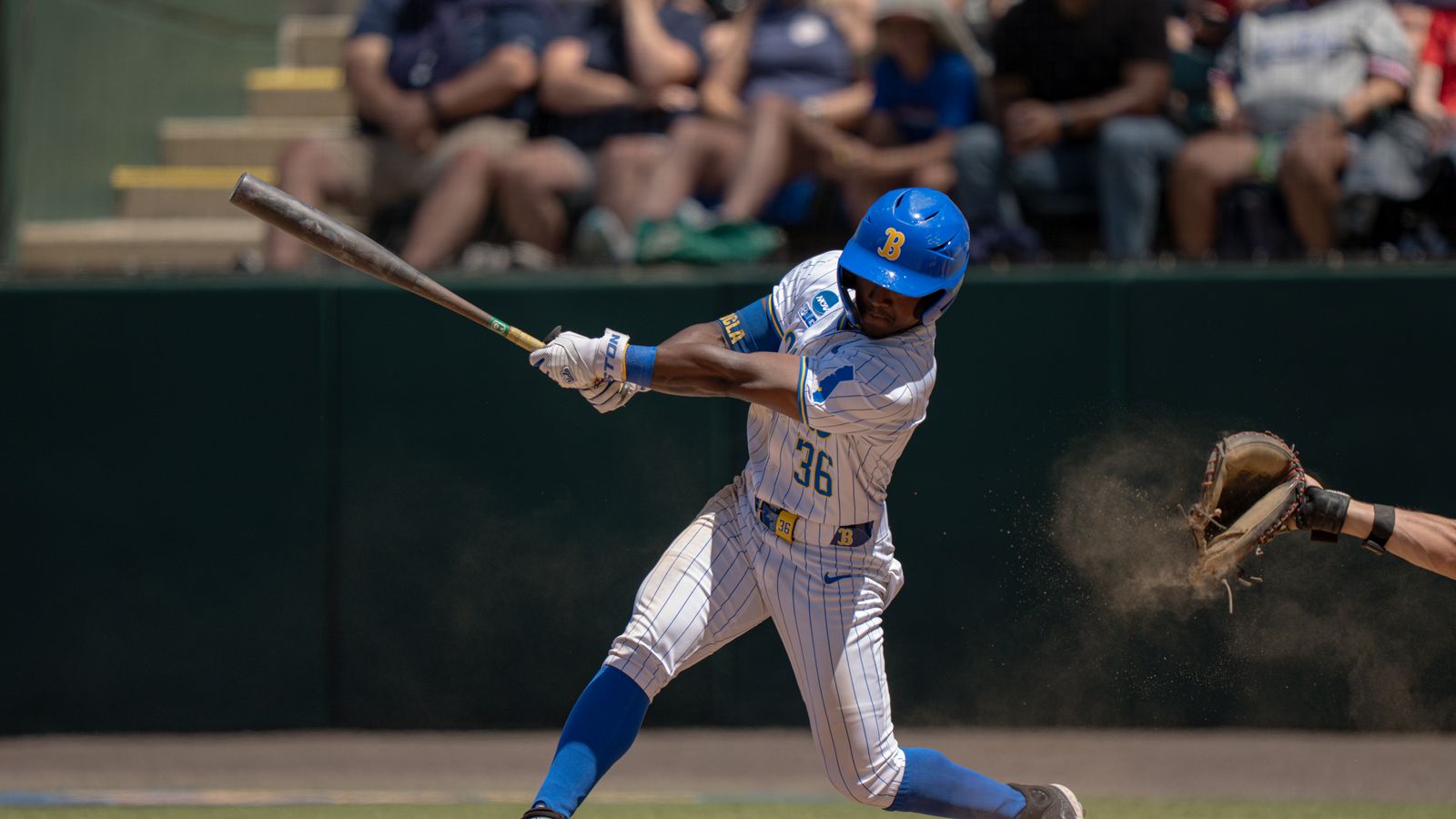 Dean West hits a foul in NCAA baseball game