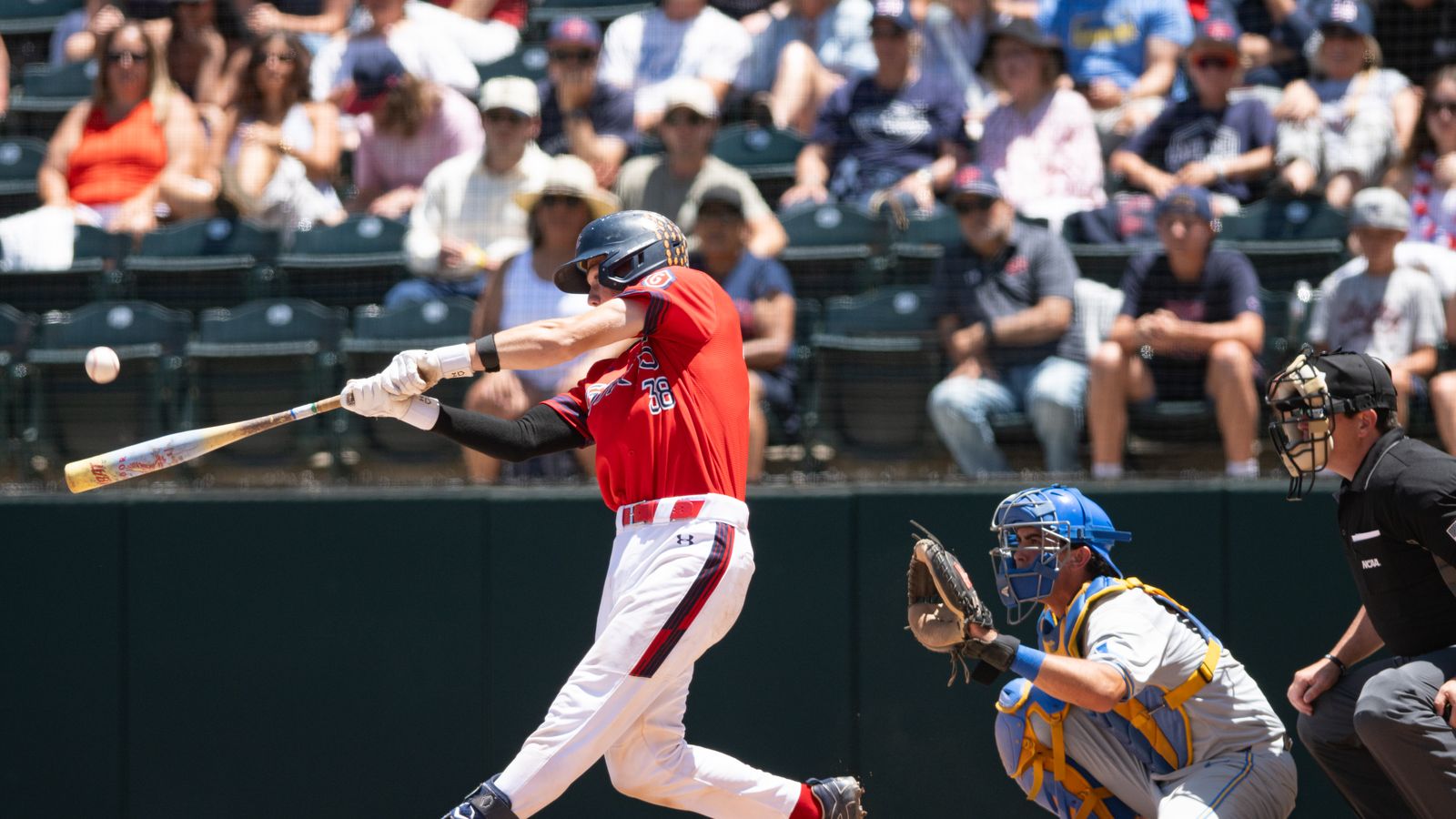 Ian Armstrong swings and makes contact in NCAA regional game