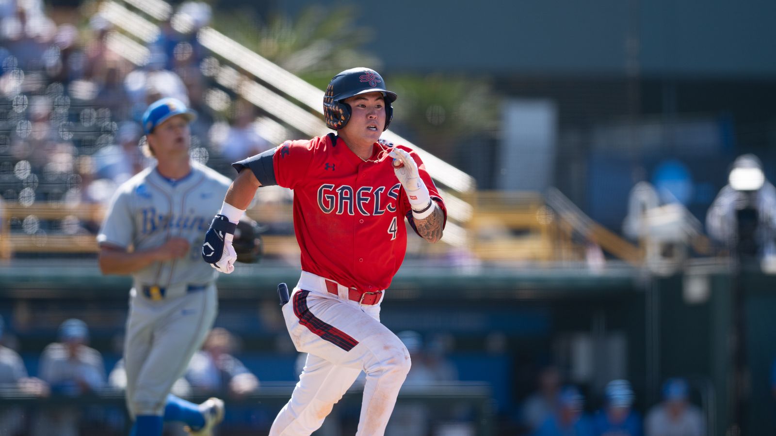 Cody Kashimoto dashes to first base after hitting