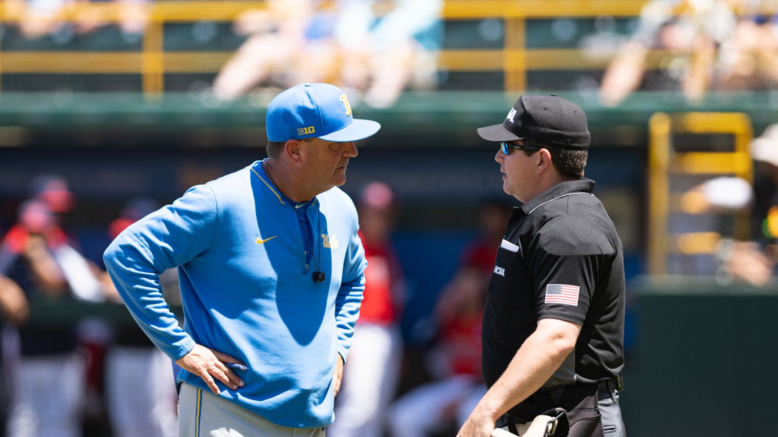 UCLA's coach John Savage discusses with the umpire