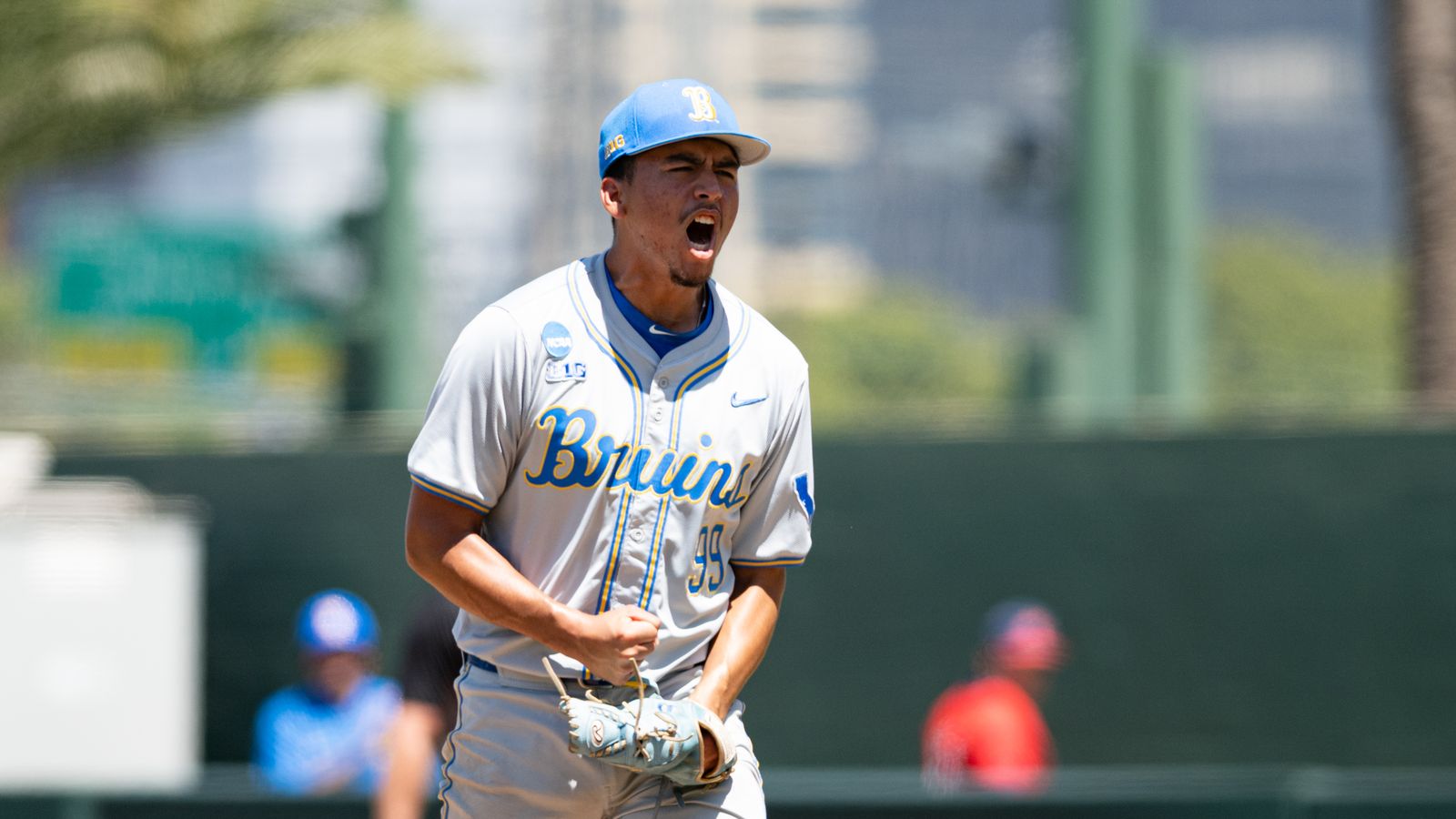 Angel Cervantes celebrates after an inning for UCLA