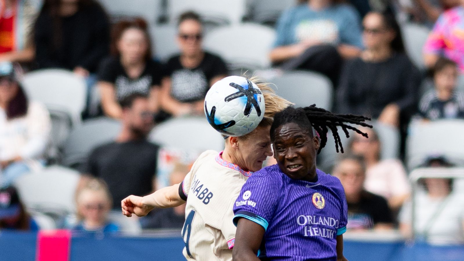 Kristen McNabb heads the ball in defensive move