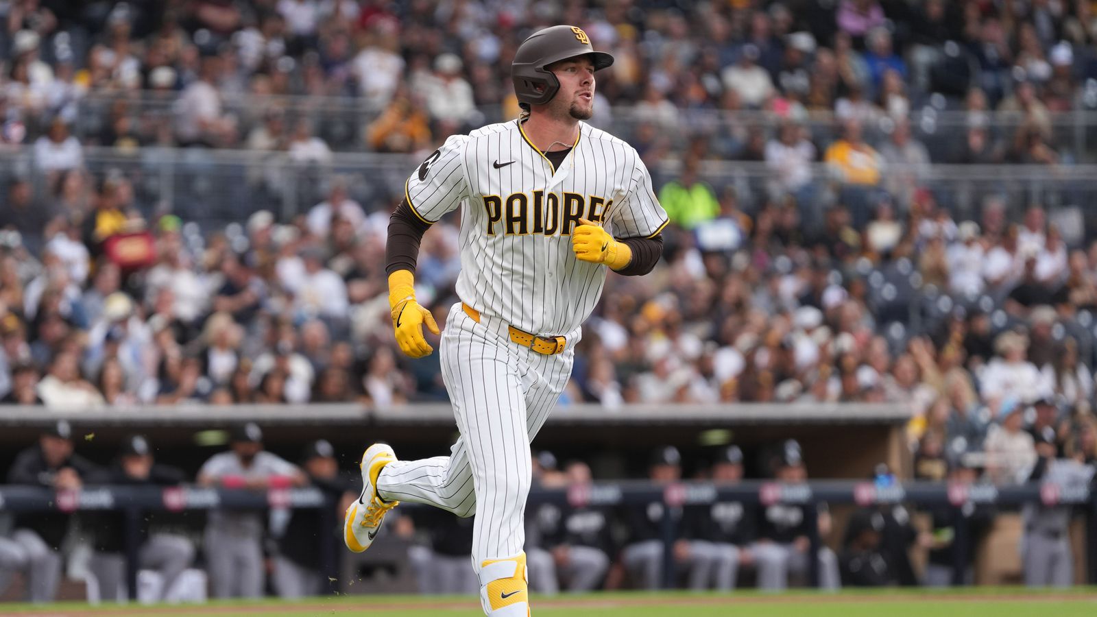 Padres center fielder Jackson Merrill (3) runs to first base