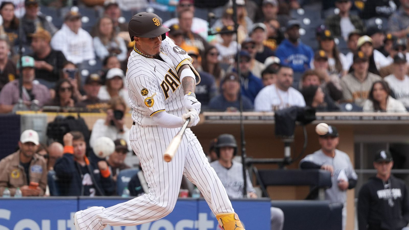 Padres third baseman Manny Machado (13) swings the bat