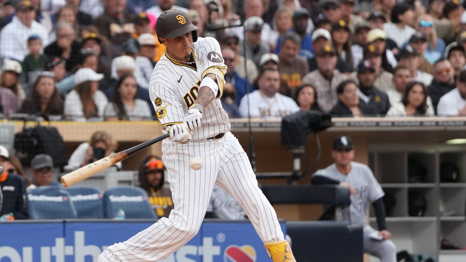 Padres third baseman Manny Machado (13) swings the bat