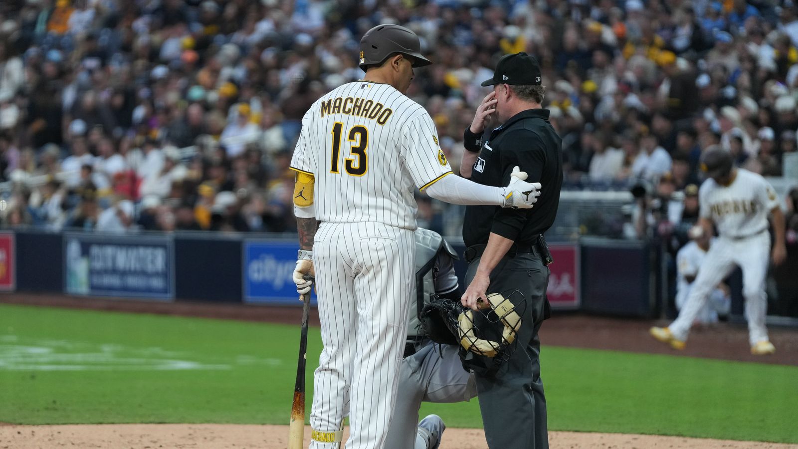 Padres third baseman Manny Machado (13) speaks to the umpire