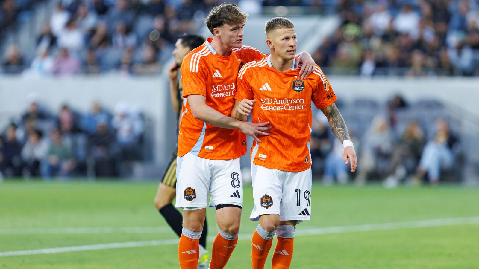 Mateusz Bogusz #19 celebrates with Jack McGlynn #8 after scoring against LAFC