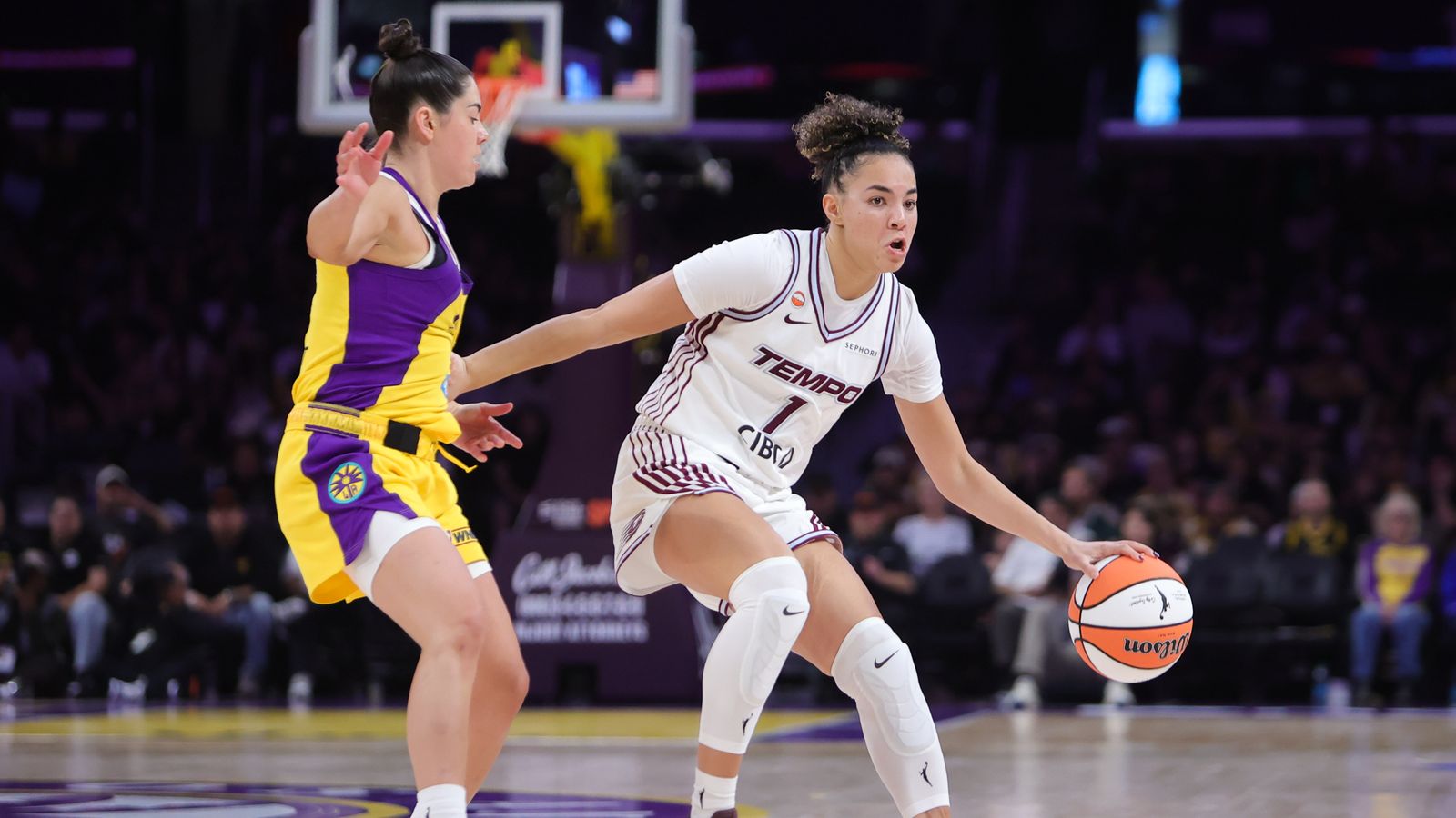 Kelsey Plum defends against Kiki Rice in WNBA action