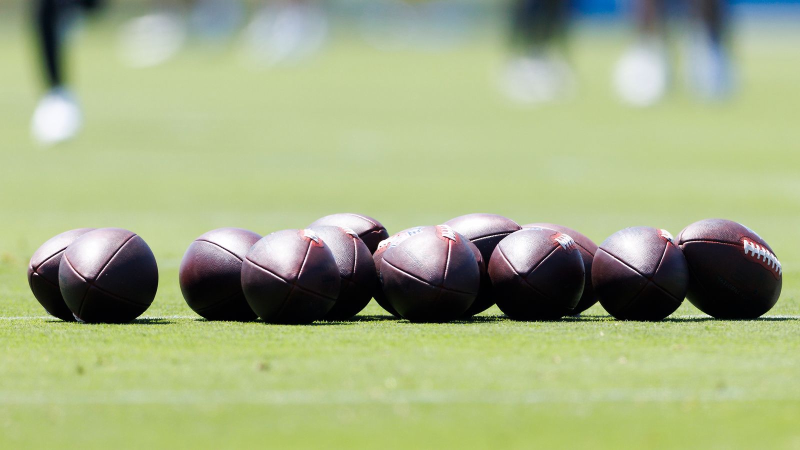 Close-up of footballs on field at Chargers' workout