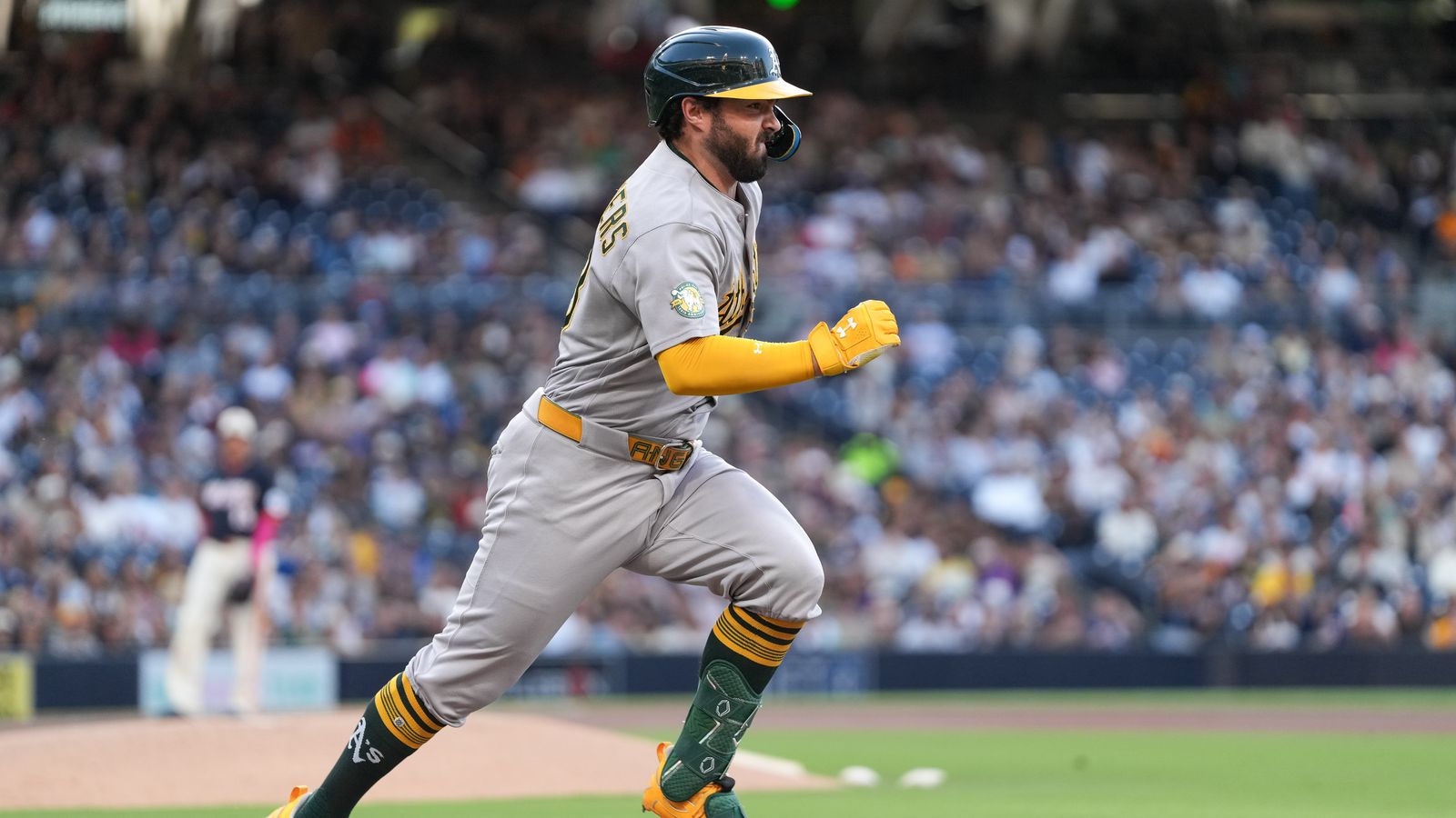 Shea Langeliers dashes to first in Padres-Athletics matchup.