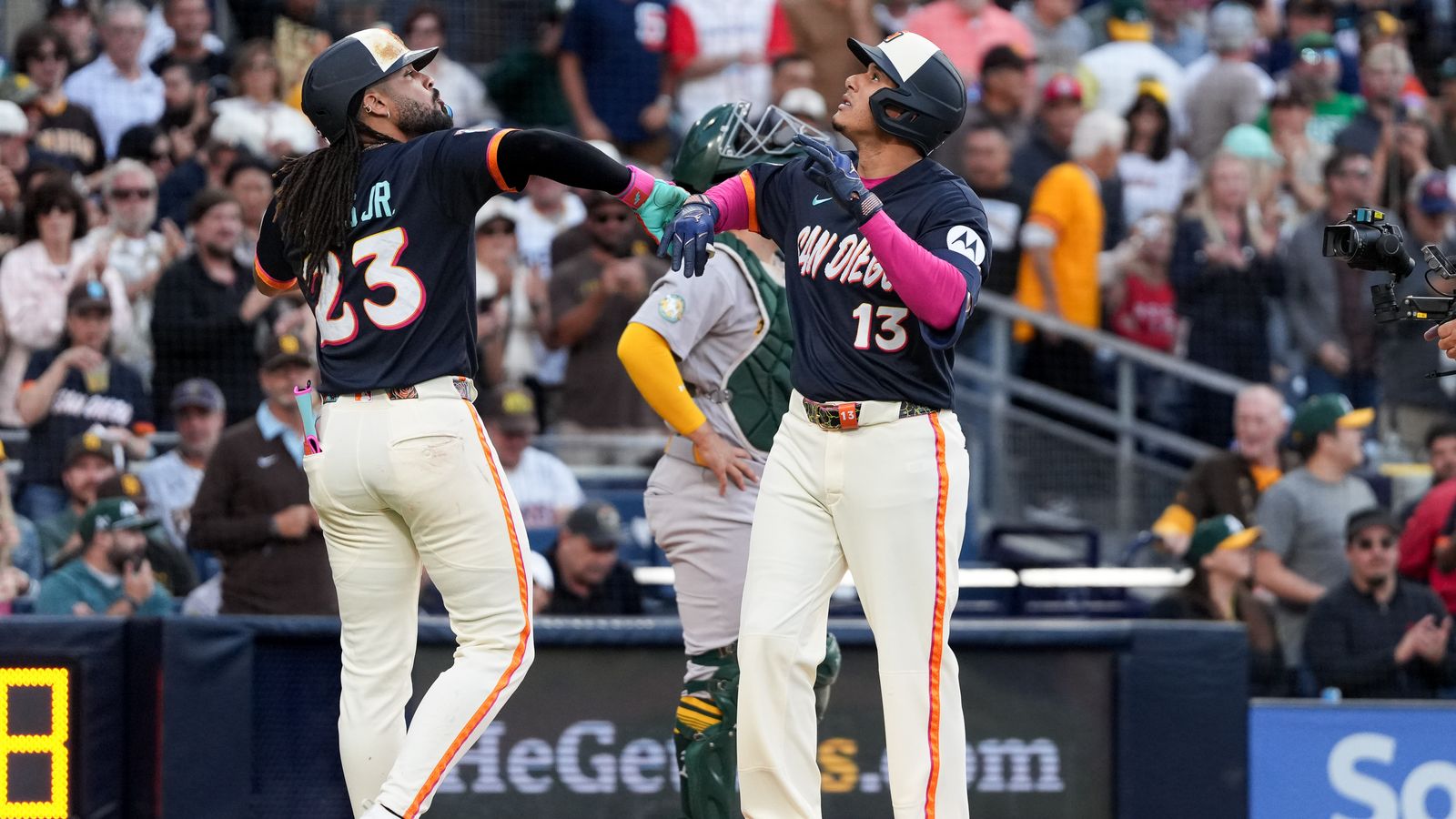 Manny Machado celebrates a home run with Fernando Tatis Jr.