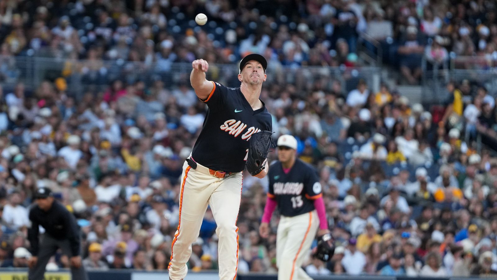 Walker Buehler makes a throw to first base against the Athletics.