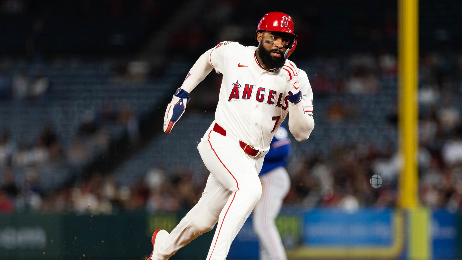 Jo Adell dashes to third base against the Rangers