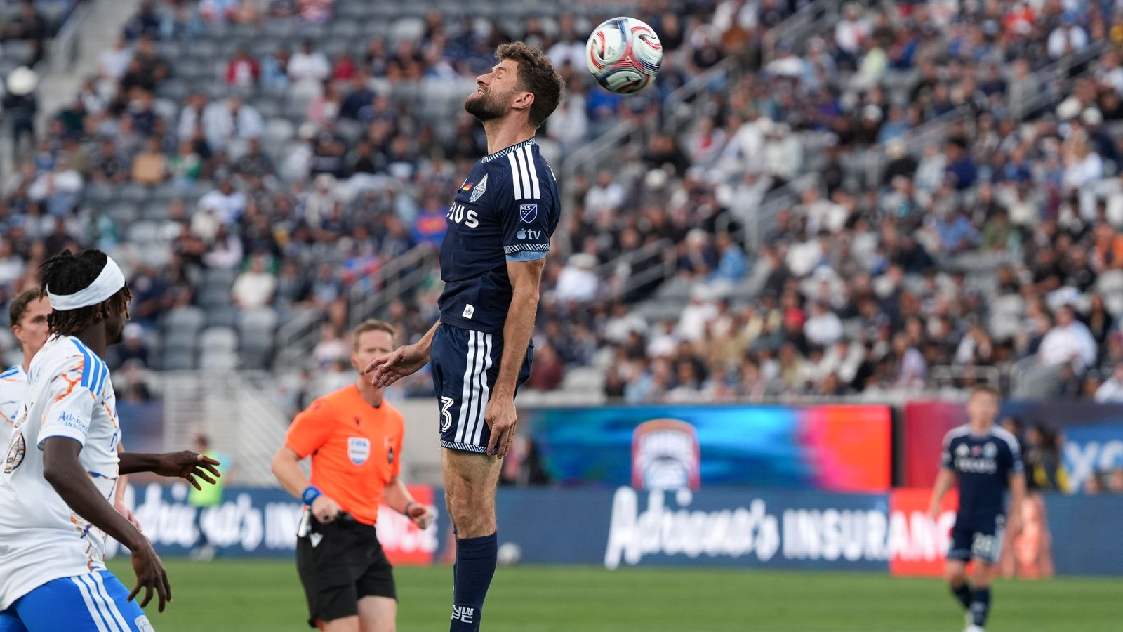 Thomas Müller heads the ball in a dynamic MLS match
