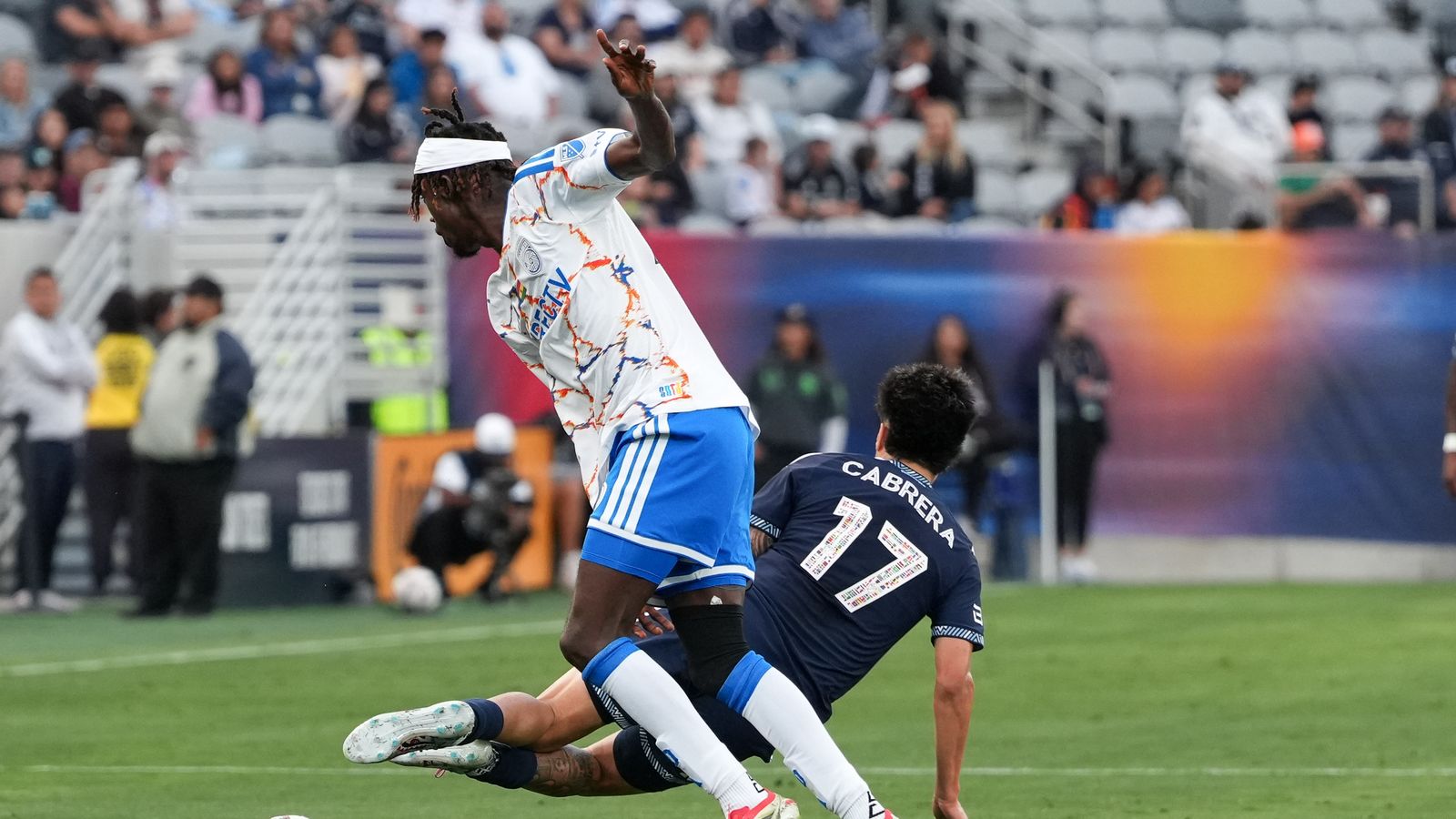Manu Duah knocks down Kenji Cabrera in MLS match