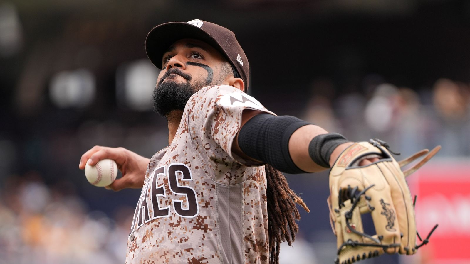 Fernando Tatis Jr. throws a ball to the stands