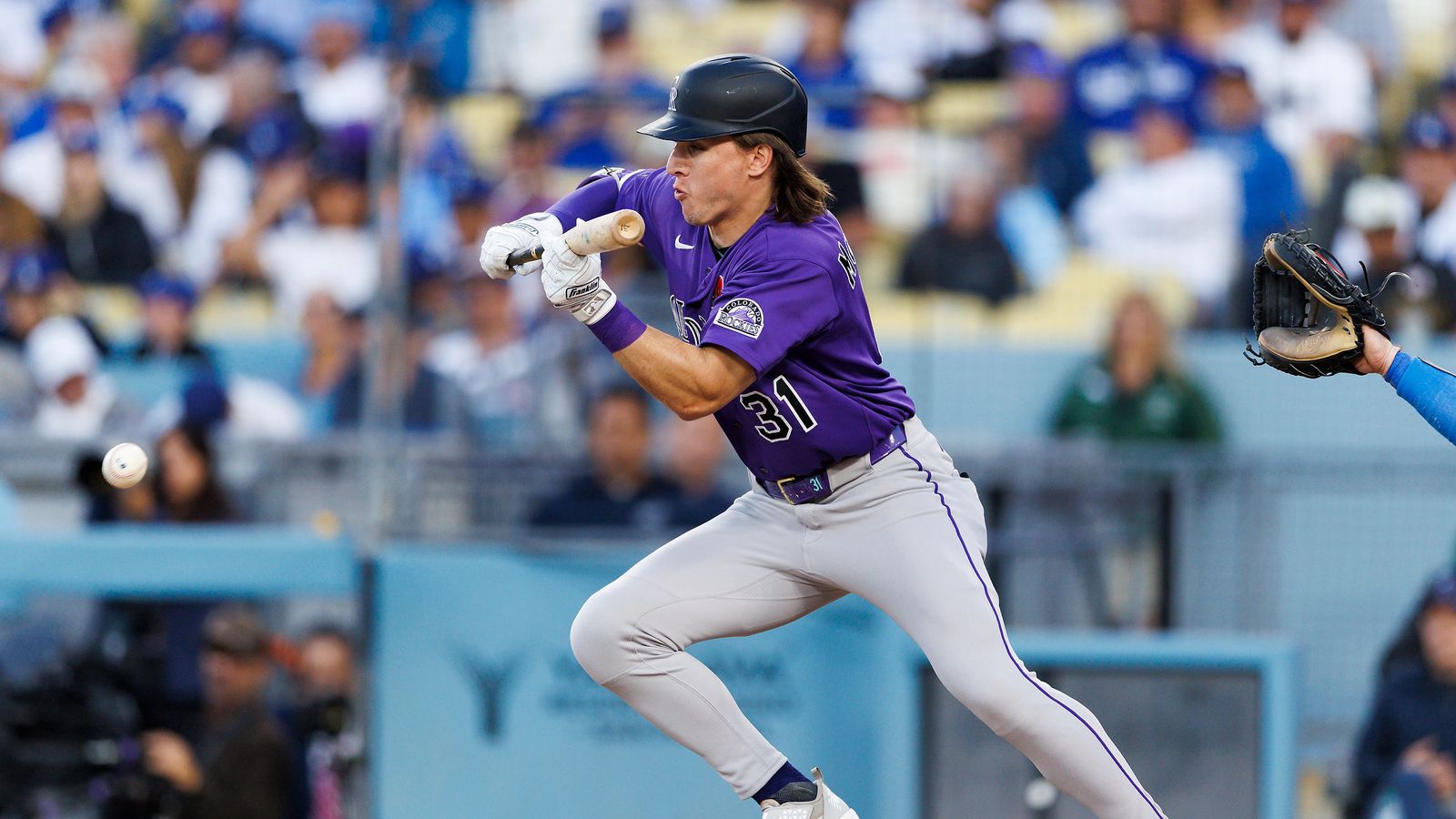 Jake McCarthy bunts during Dodgers-Rockies matchup